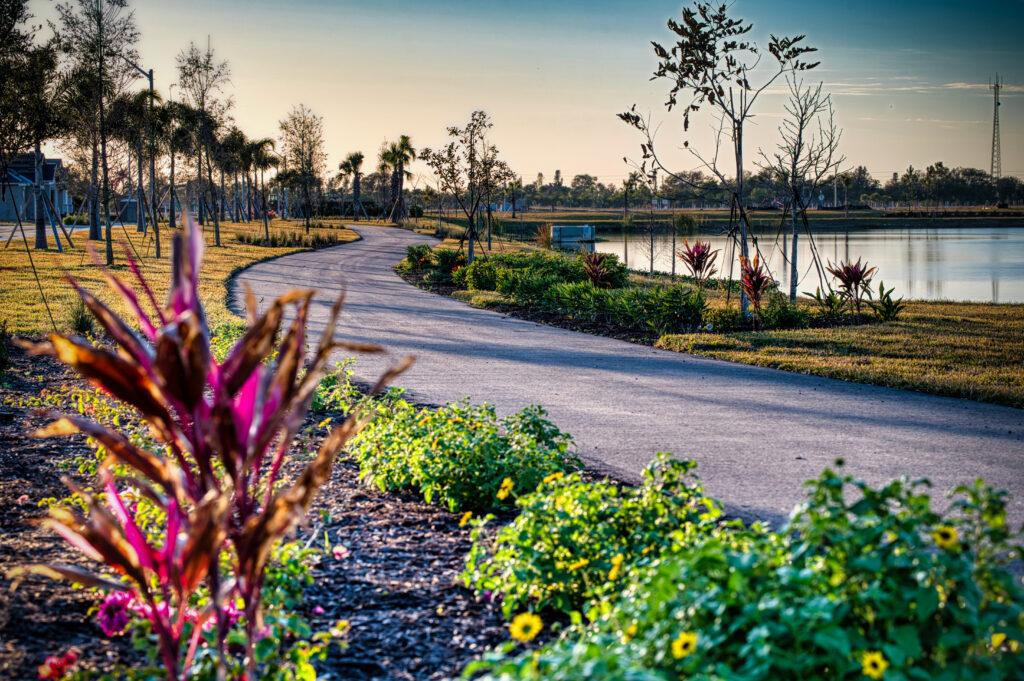 View of outdoor road and gardens overlooking lake